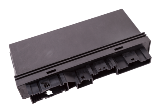 Plastic car engine control unit with metal elements on a white isolated background is the connecting center of various subsystems, units and assemblies. Monitoring the state of the moment. Spare part