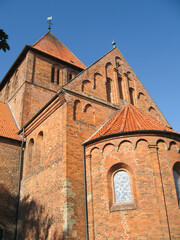 Fototapeta premium Looking up at the belltower of the 13’th century brick church at the cannon monastery in the German Town of Bassum on a clear sunny day.