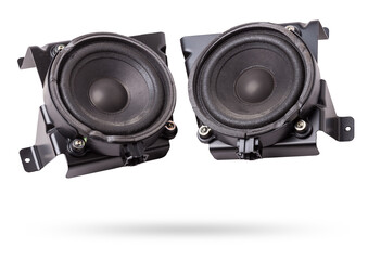 Two speakers of an acoustic system - an audio for playing music in a car interior on a white isolated background in a photo studio. Spare parts for auto repair in a workshop or for sale for tuning