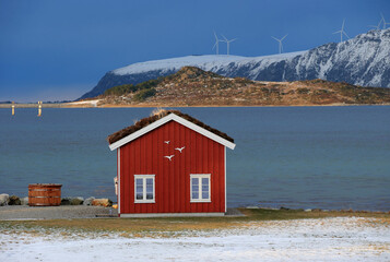 Winter landscape with red boathouse near Alesund, Norway. - 781469417