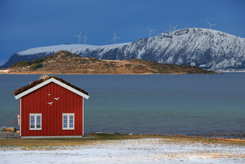 Winter landscape with red boathouse near Alesund, Norway. - 781469430