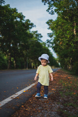 A child walks in an autumn park surrounded by nature