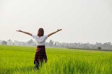 A joyful woman leaps in a sunny meadow, embodying freedom and happiness in nature