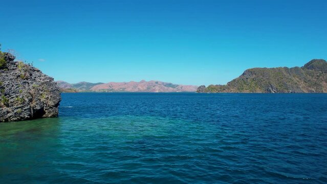 4K Aerial drone video of Siete Pecados Siete with boats surrounded by blue sea. Coron, Palawan. Philippines.