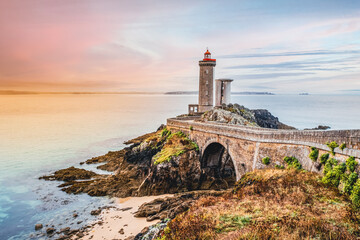 One of the most beautiful lighthouses at sunset. Phare de Petit Minou on the coast of Brittany, France, Europe - obrazy, fototapety, plakaty