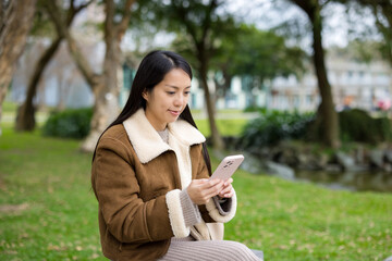 Woman use of mobile phone at park