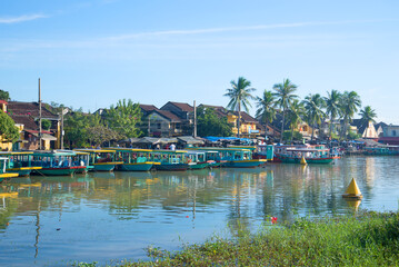 Fototapeta na wymiar Early morning on the Thu Bon river. The historic town centre of Hoi An