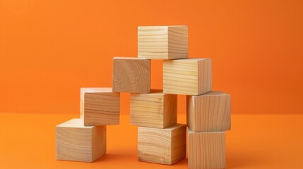 Stacked wooden blocks on orange surface