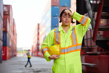 technician or worker have a headache and feeling tired from work in containers warehouse storage