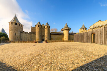 Front view of the bridge and facade of Château Comtal, the large, restored 12th-century hilltop...