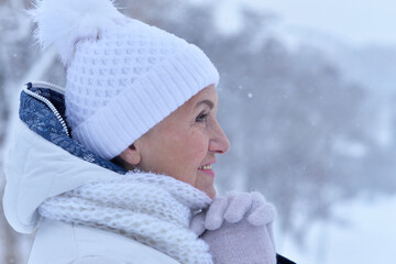 Happy senior woman posing at winter park