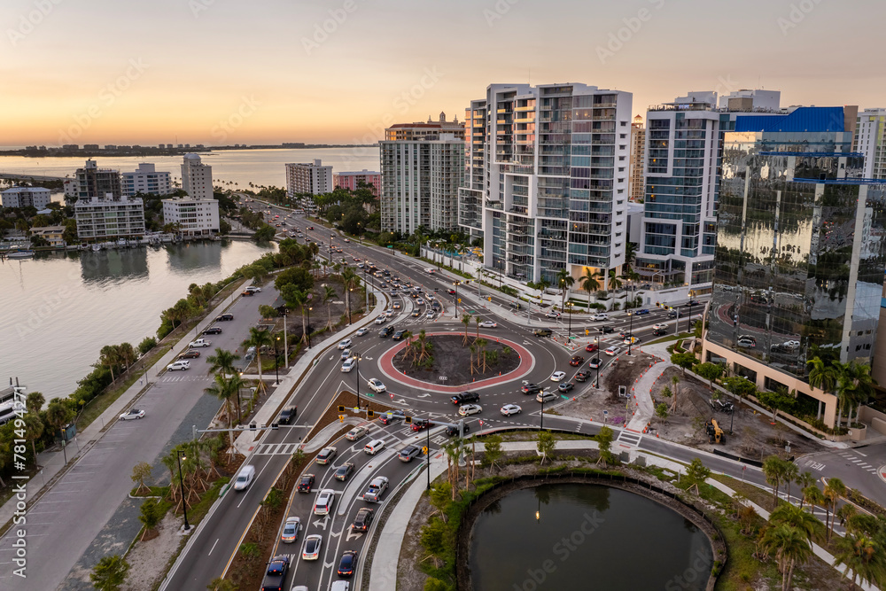 Poster Driving traffic cars at Gulfstream Avenue roundabout intersection. Traffic circle on American road with moving cars