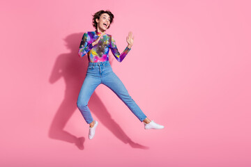 Fototapeta na wymiar Full size photo of nice young woman jump look empty space wear pullover isolated on pink color background