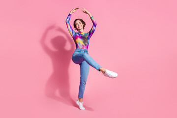 Full size photo of nice young woman dance empty space wear pullover isolated on pink color background