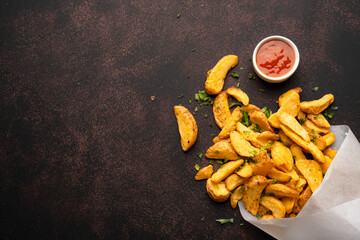 Delicious potato wedges on the black background