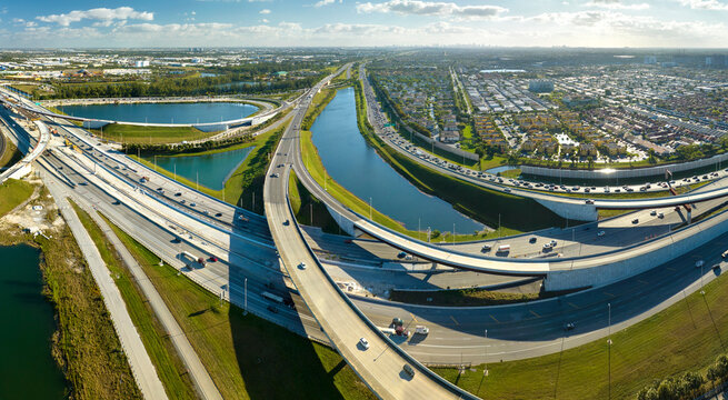 USA transportation infrastructure concept. Above view of wide highway crossroads in Miami, Florida with fast driving cars