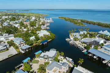 Wealthy neighborhood in small town Boca Grande, Florida with expensive waterfront houses between...