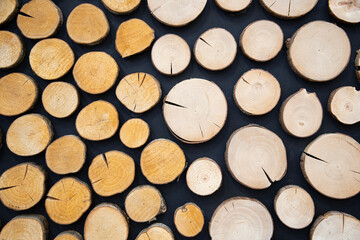 Background texture   of a cross section of cut ends of round wooden logs . Soft focus . Wooden background