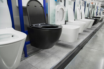 Toilet bowls in a home goods store.  New modern black toilet