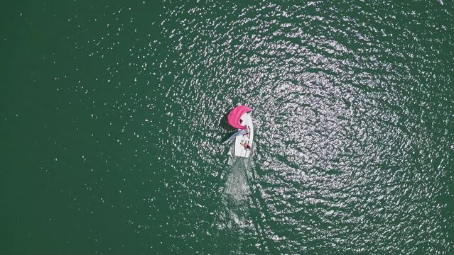 Top aerial view on lonely boat in Newport Beach in Orange County California on sunny day, USA. High quality 4k footage