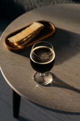 Glass with dark beer and potato chips on marble table. Beer and snacks concept 