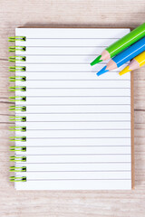 Notebook for notes and crayons. Office and stationery accessories used at school or preschool