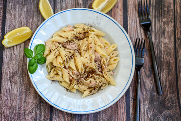  Italian home made   penne pasta  with  tuna  fish, parmesan cheese and black pepper .