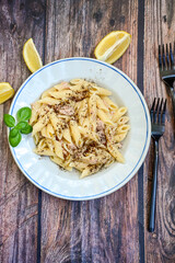  Italian home made   penne pasta  with  tuna  fish, parmesan cheese and black pepper .