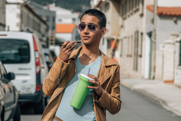 teenager sending an audio or message by phone on the street