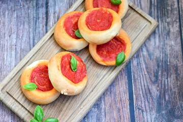 Mini margherita napoletan pizza with tomato,mozzarella  cheese and basil,  on wooden background