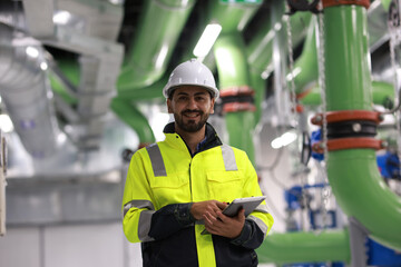 Portrait of an energy engineer Working to inspect the cooling system of the air conditioner in the basement of the building.