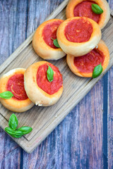 Mini margherita napoletan pizza with tomato,mozzarella  cheese and basil,  on wooden background