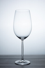 clear crystal wine glass with elegant stand of empty glass without liquid, resting on a table