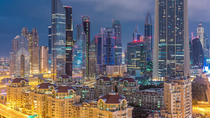 Skyline view of the buildings of Sheikh Zayed Road and DIFC night to day timelapse in Dubai, UAE.