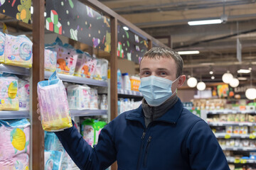 A man in a protective face mask in a supermarket. Retail trade. Quarantine