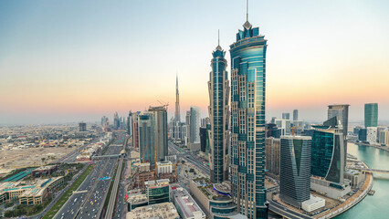 Evening skyline with modern skyscrapers and traffic on sheikh zayed road day to night timelapse in...
