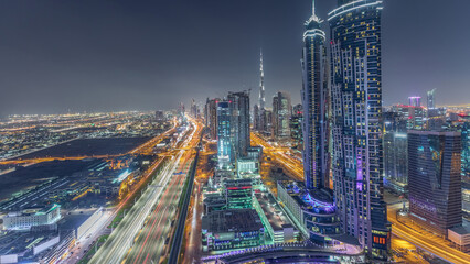 Evening skyline with modern skyscrapers and traffic on sheikh zayed road night timelapse in Dubai,...