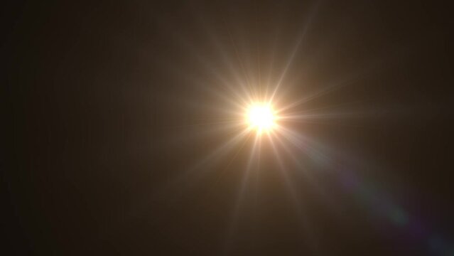 Glowing golden starburst emitting rays in a dark, muted environment.