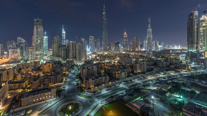 Dubai Downtown skyline night to day timelapse with Burj Khalifa and other towers panoramic view from the top in Dubai