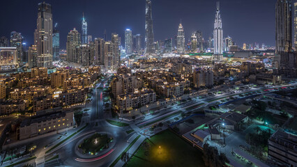Aerial view of a roundabout circle road in Dubai downtown from above night timelapse. Dubai, United...