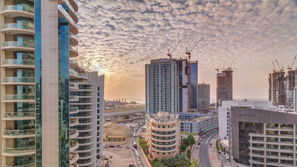 Dubai Marina skyscrapers, port with luxury yachts and Marina promenade aerial sunset timelapse