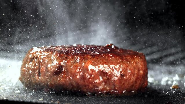 Super slow motion burger fried in a frying pan. High quality FullHD footage