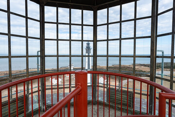 The New Cape Henry Lighthouse as viewed from the top of the Old Cape Henry Lighthouse in Virginia...