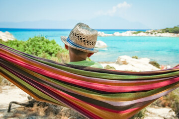 happy child by the sea on hammock in greece background - 781532249