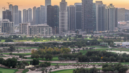 Jumeirah lake towers skyscrapers and golf course day to night timelapse, Dubai, United Arab Emirates