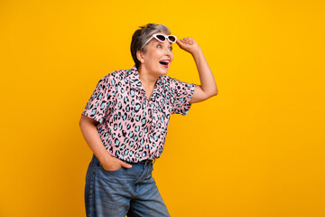 Photo of lovely senior lady take off sunglass shock look empty space wear trendy leopard print garment isolated on yellow color background - obrazy, fototapety, plakaty