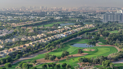 Aerial view to villas and houses with Golf course with green lawn and lakes timelapse - obrazy, fototapety, plakaty