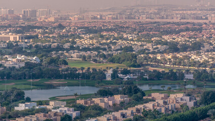 Aerial view to villas and houses with Golf course with green lawn and lakes timelapse