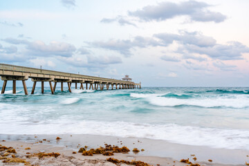 Fototapeta premium pier over ocean with sunset