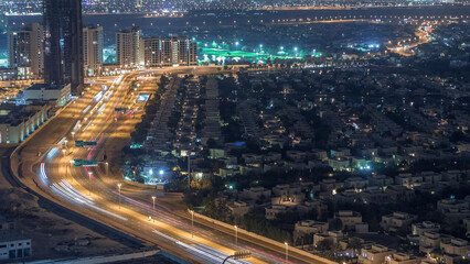 Aerial view of apartment houses and villas in Dubai city night timelapse, United Arab Emirates
